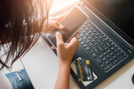 Online payment,Woman's hands holding smartphone and using credit card for online shopping.