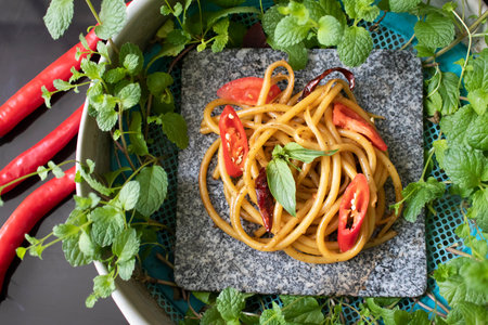 Spaghetti with spicy  on stone panの写真素材