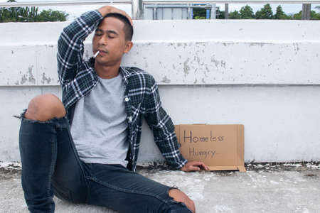 Homeless man smoking.Unhappy homeless manの写真素材