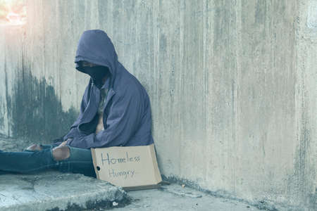 Unhappy homeless man under the bridgeの写真素材