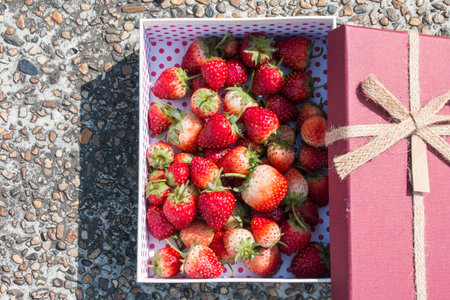 Fresh strawberry in gift box on stone backgroundの写真素材