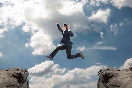 Asian Businessman  jump on blue sky,Business success conceptの写真素材