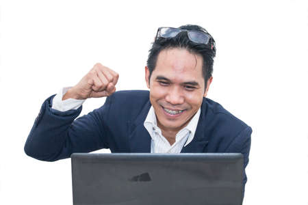 Asian businessman keeping arms raised and expressing positivity on white background,Celebrating successの写真素材