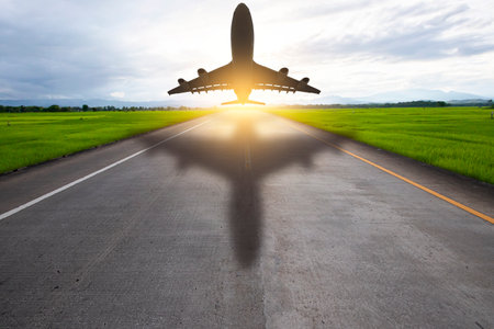 Plane taking off from airport runways for traveling and transport businessの写真素材
