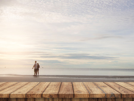 Wood table top on blurred  sand beach background with some peopleの写真素材