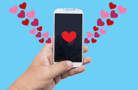 Sending love messages on smartphone,Social media addictionの写真素材