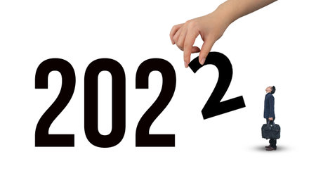 Asian business man looking male hand holding number 2 with 2022の写真素材