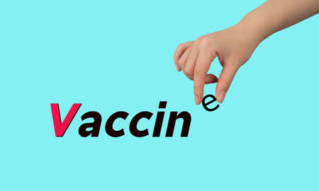 Vaccine with women hand on blue backgroundの写真素材