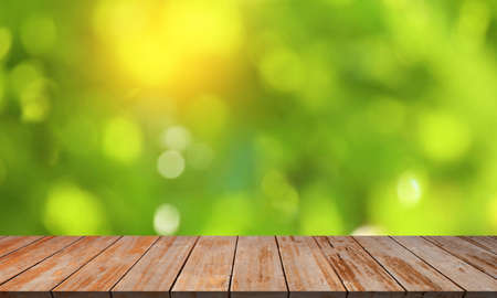 Wood floor with blurred trees of nature park backgroundの写真素材