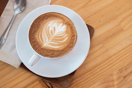 Top view latte coffee on wood tableの写真素材