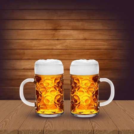 Two glasses of light beer on wooden tableの写真素材