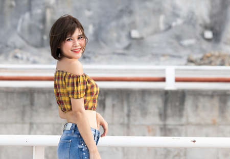 Portrait of asian woman smiling outdoorsの写真素材
