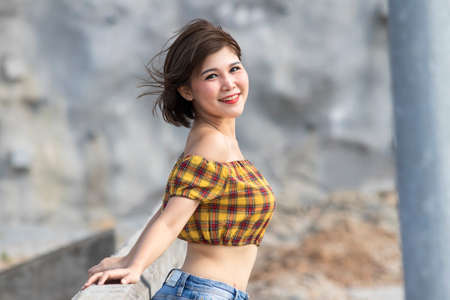 Portrait of asian woman smiling outdoorsの写真素材
