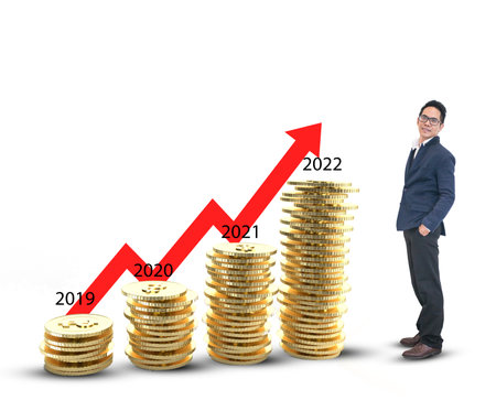 Businessman standing with  the gold coins on white backgroundの写真素材