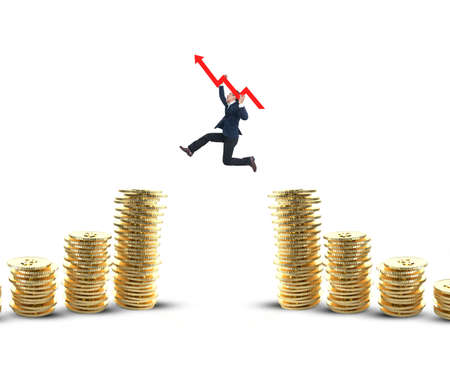 Businessman jumping with arrow on the gold coins on white backgroundの写真素材
