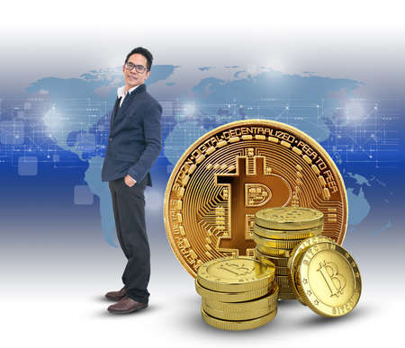 Asian business man standing with bitcoin . Cryptocurrency trading conceptの写真素材