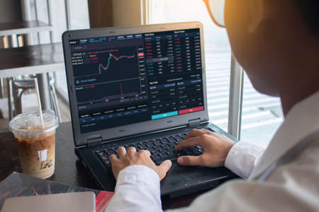 Businessman managing stock market, discussing stock market graphs, trading stocks, traders concepts.の写真素材
