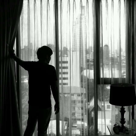 A man look at the world from his lonely roomの素材