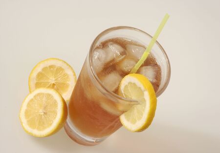 Glass of Iced Tea with a slice of lemonの写真素材