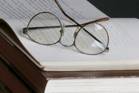 eye glasses set on top of a open pageの写真素材