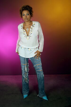 pretty African American woman on black background lite with pink and gold lightの写真素材