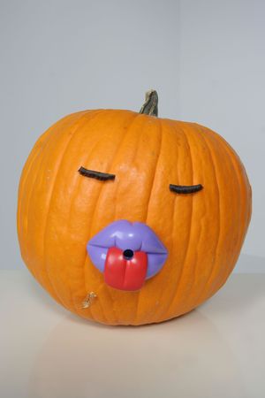 vertical pumpkin in big purple lips and stick out tongueの写真素材