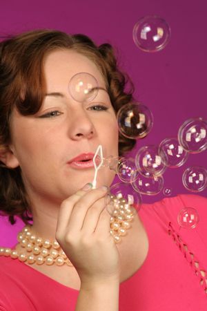 close up of a girl blowing bubblesの写真素材