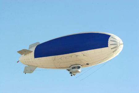 blimp flying in clear blue sky with blue copy space to advertise your messageの写真素材