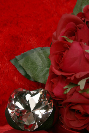 furry red background with crystal heart with red rosesの写真素材