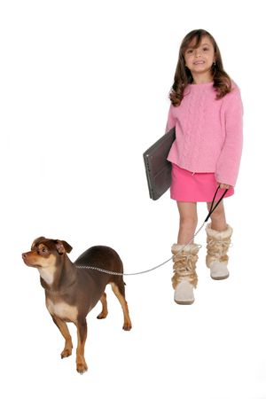 isolated on white young girl take's dog for a walk carrying her laptopの写真素材