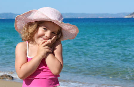 beauty little girl with straw hat portraitの写真素材