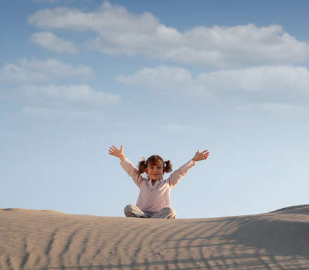 happy little girl in desertの写真素材