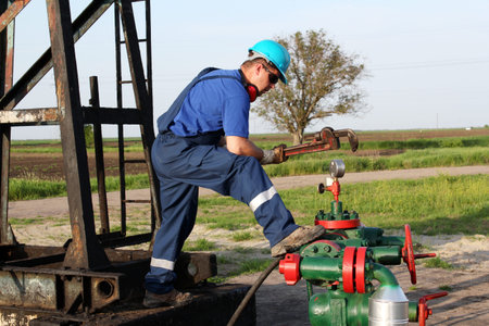 oil worker with wrench check pipelineの写真素材
