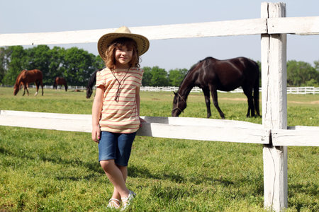 little girl on horse farmの写真素材