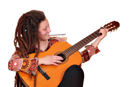 girl with dreadlocks hair play acoustic guitar