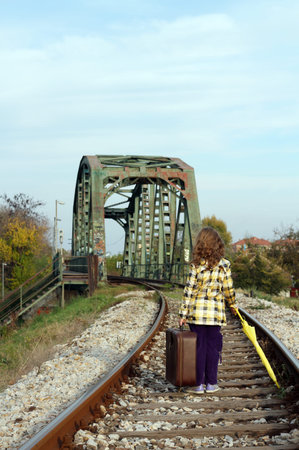 little girl walking on railroadの写真素材