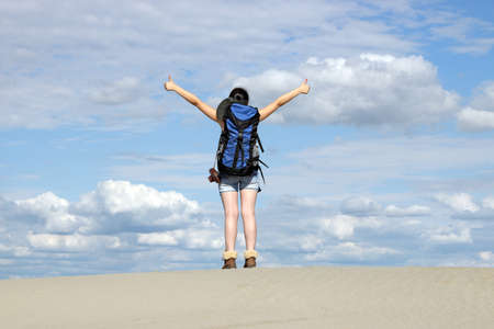 girl hiker with thumbs up in desertの写真素材