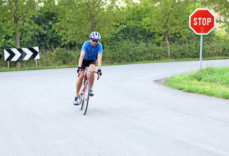 male cyclist riding a bike on an roadの写真素材