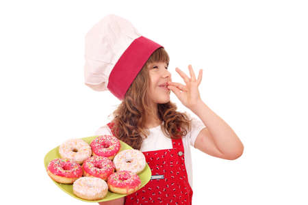 little girl cook with sweet donuts and ok hand signの写真素材