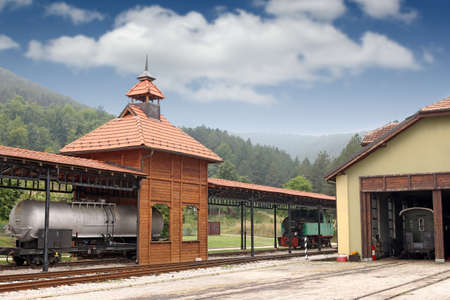 old railway station with steam locomotiveの写真素材