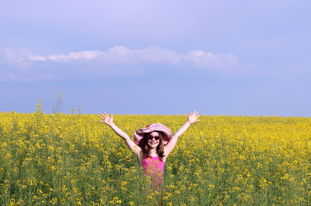 happy little girl on field summer season