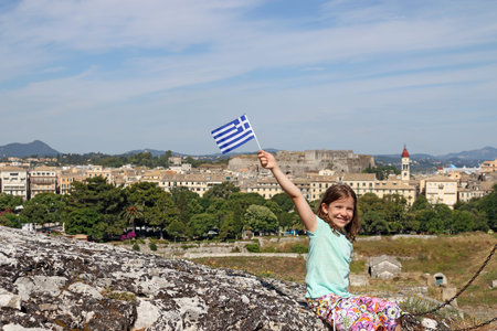 happy little girl with Greek flag Corfu town Greeceの写真素材
