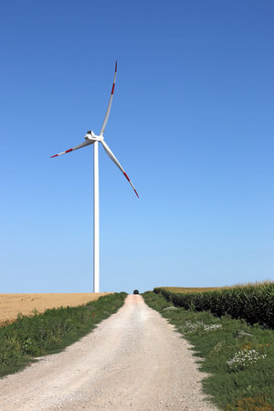 wind turbine on field with country road