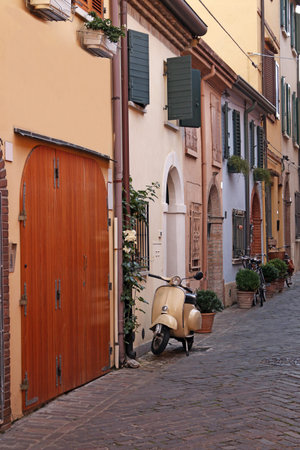 street with scooter and old houses Rimini Italyの写真素材