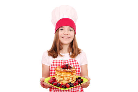 happy little girl cook with pancakesの写真素材