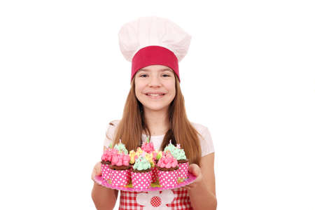 Happy little girl cook with muffins on plateの写真素材