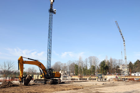 Digging excavator on new building construction site