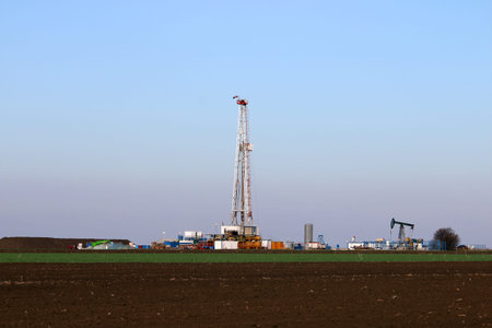 Oil and gas drilling rig and pump jack in oilfield