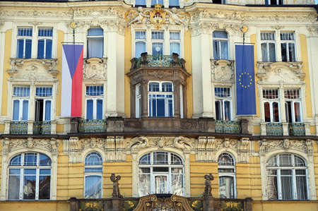 an old building with a Czech and European Union flag in Pragueの写真素材