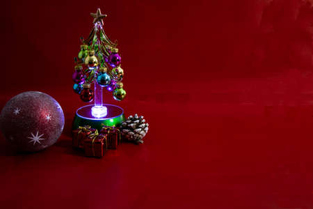 Christmas tree with gifts on red background with writing space.Christmas balls, Christmas tree and gifts.の写真素材